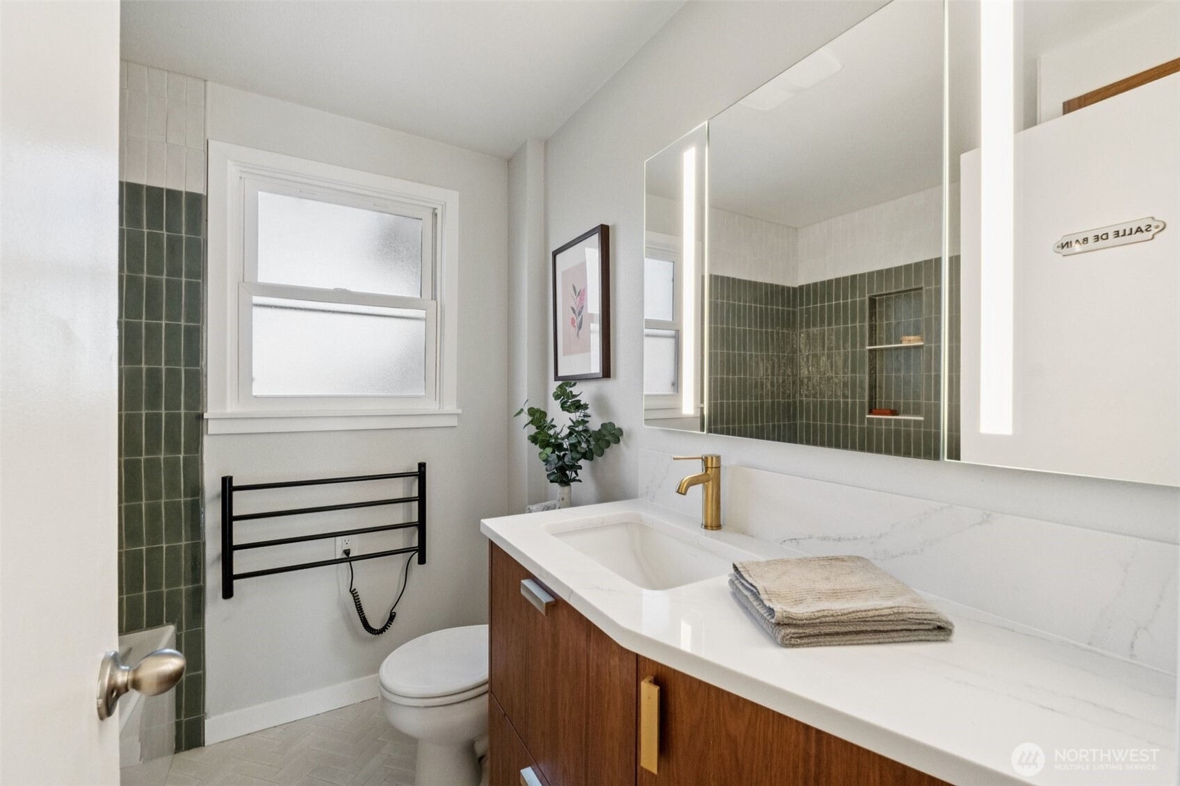 730 Northwest 73rd Street Seattle, WA 98117 - Photo 19 of 39 a bathroom with a sink a toilet and a mirror