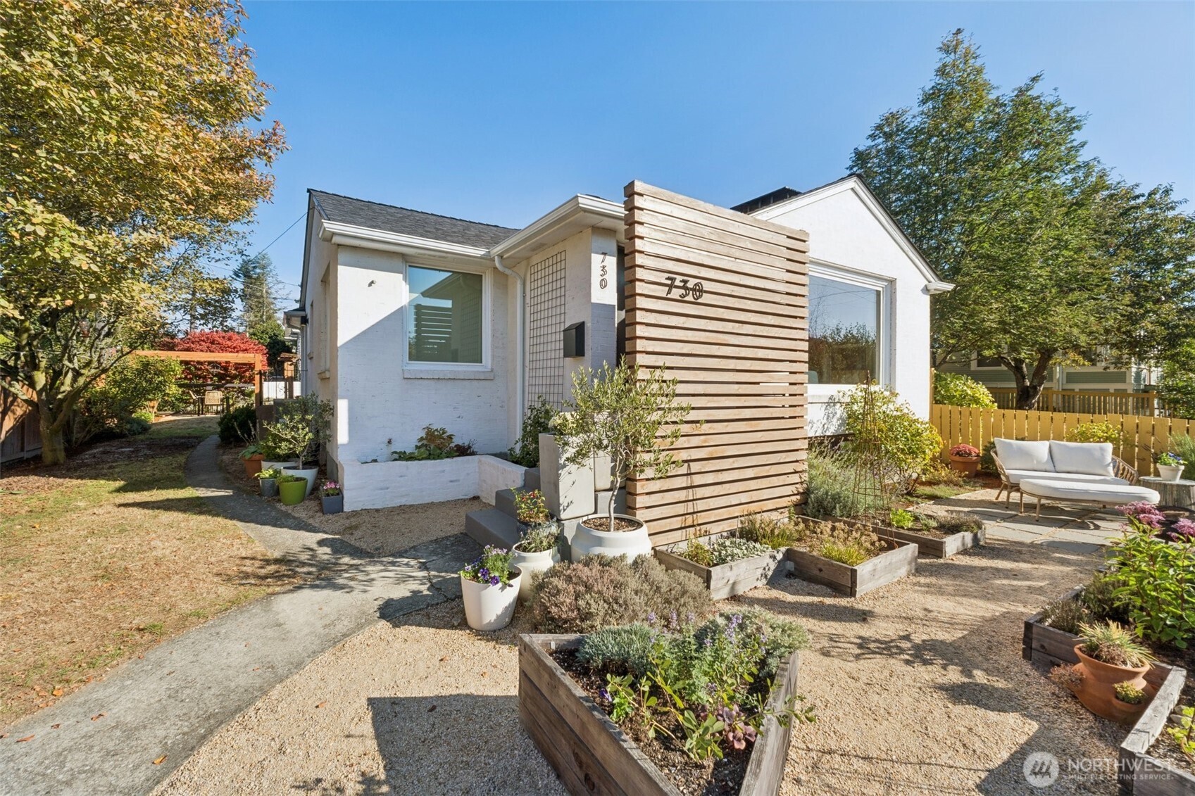 730 Northwest 73rd Street Seattle, WA 98117 - Photo 2 of 39 a view of a patio with couches table and chairs and potted plants