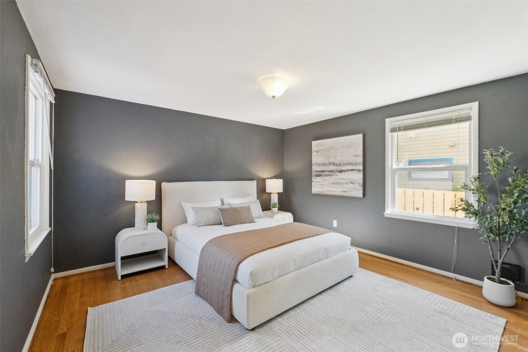 730 Northwest 73rd Street Seattle, WA 98117 - Photo 21 of 39 a bedroom with a bed lamp and window