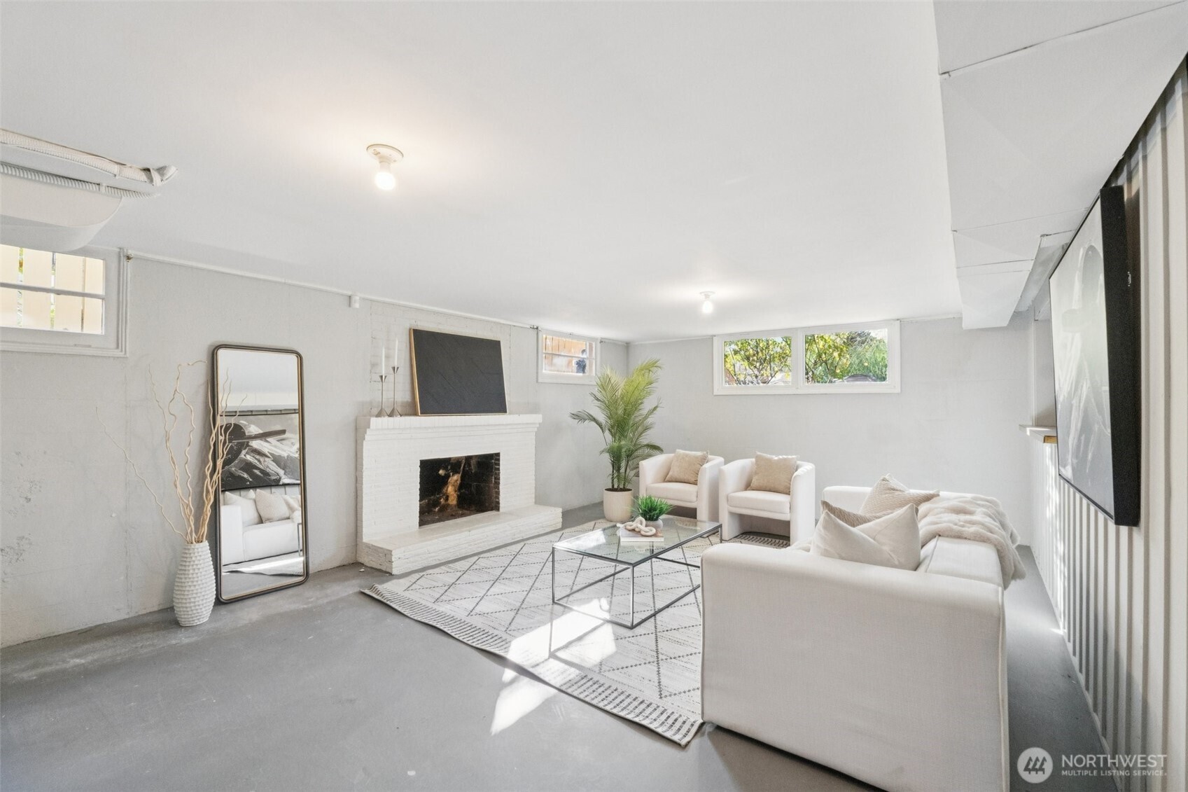 730 Northwest 73rd Street Seattle, WA 98117 - Photo 24 of 39 a living room with furniture a fireplace and a flat screen tv