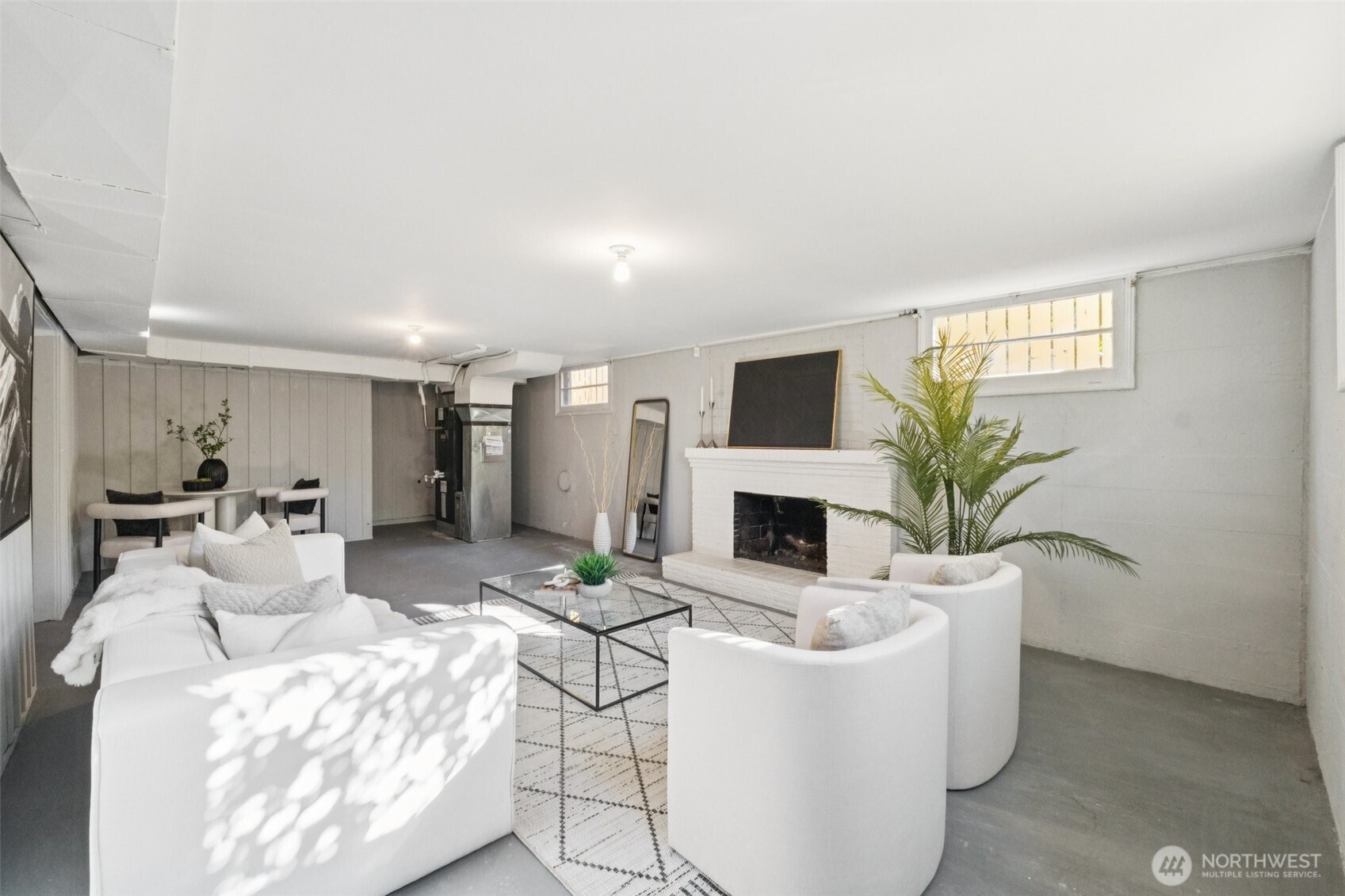 730 Northwest 73rd Street Seattle, WA 98117 - Photo 25 of 39 a living room with furniture a fireplace and a potted plant