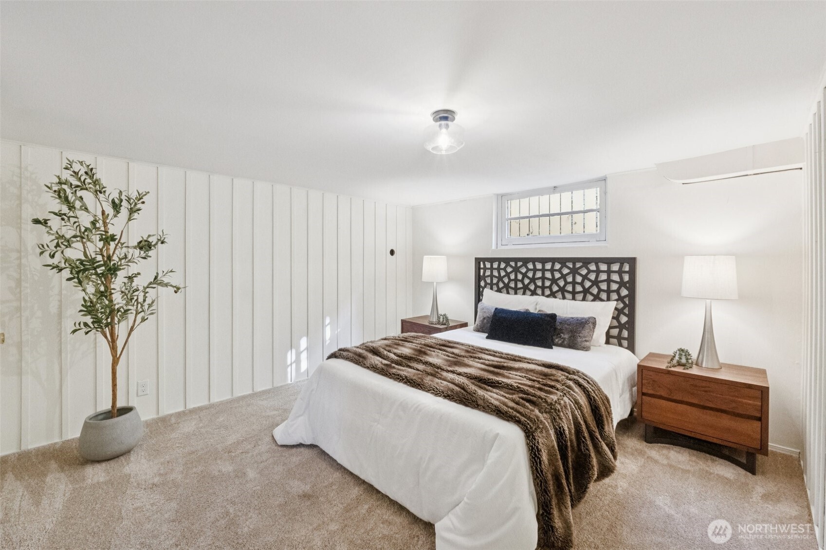 730 Northwest 73rd Street Seattle, WA 98117 - Photo 33 of 39 a bedroom with a bed and a potted plant