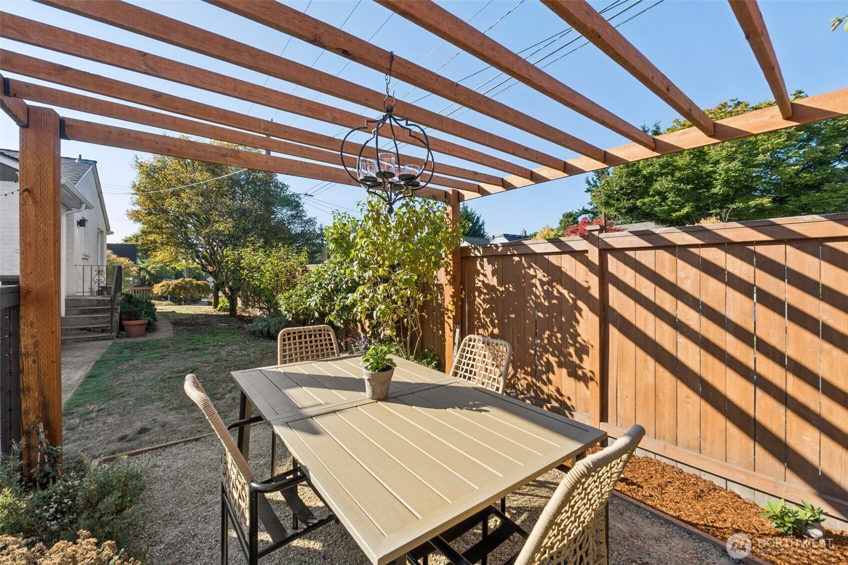 730 Northwest 73rd Street Seattle, WA 98117 - Photo 37 of 39 a view of a patio with table and chairs and potted plants