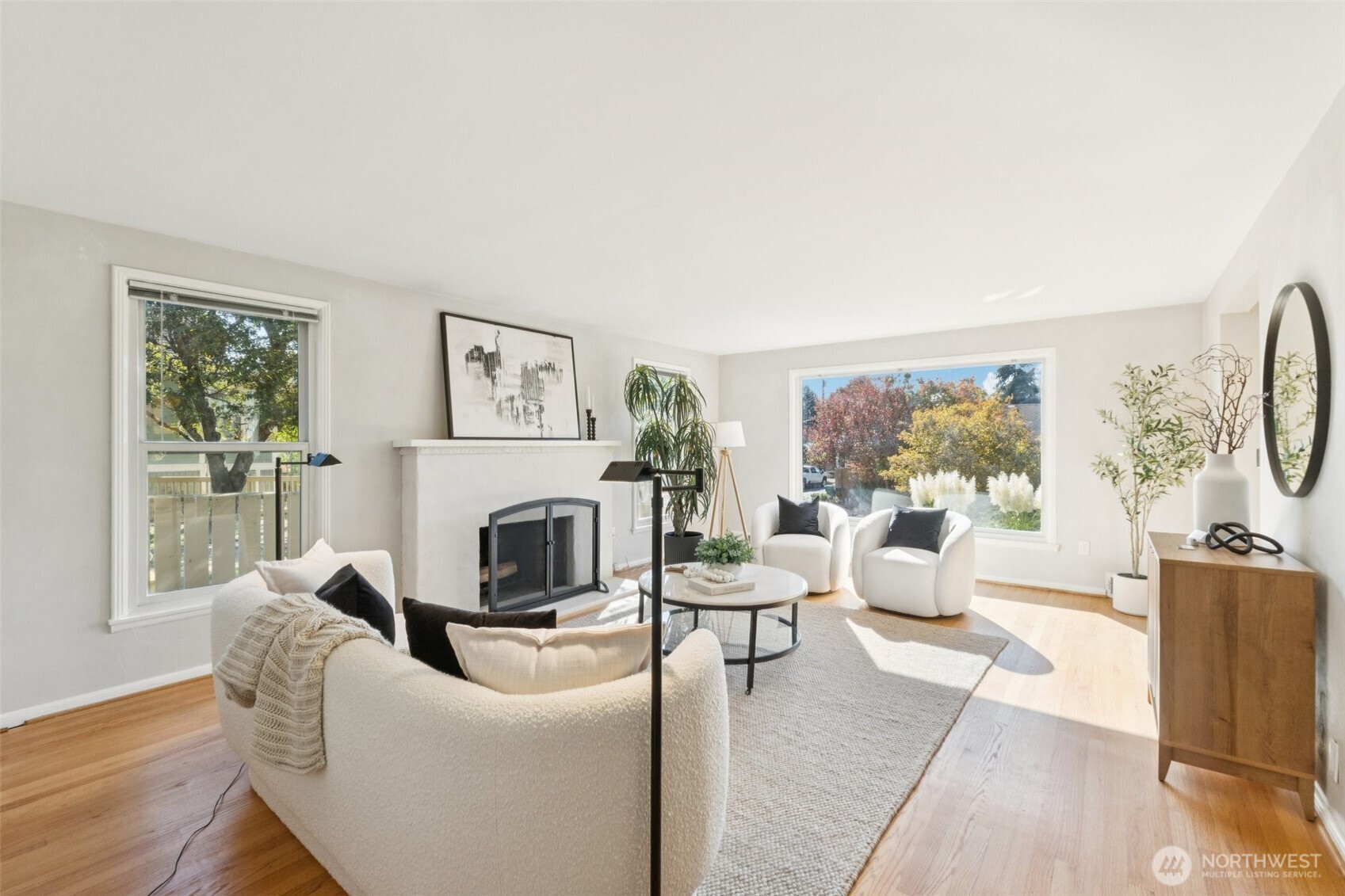 730 Northwest 73rd Street Seattle, WA 98117 - Photo 8 of 39 a living room with furniture a large window and a fireplace