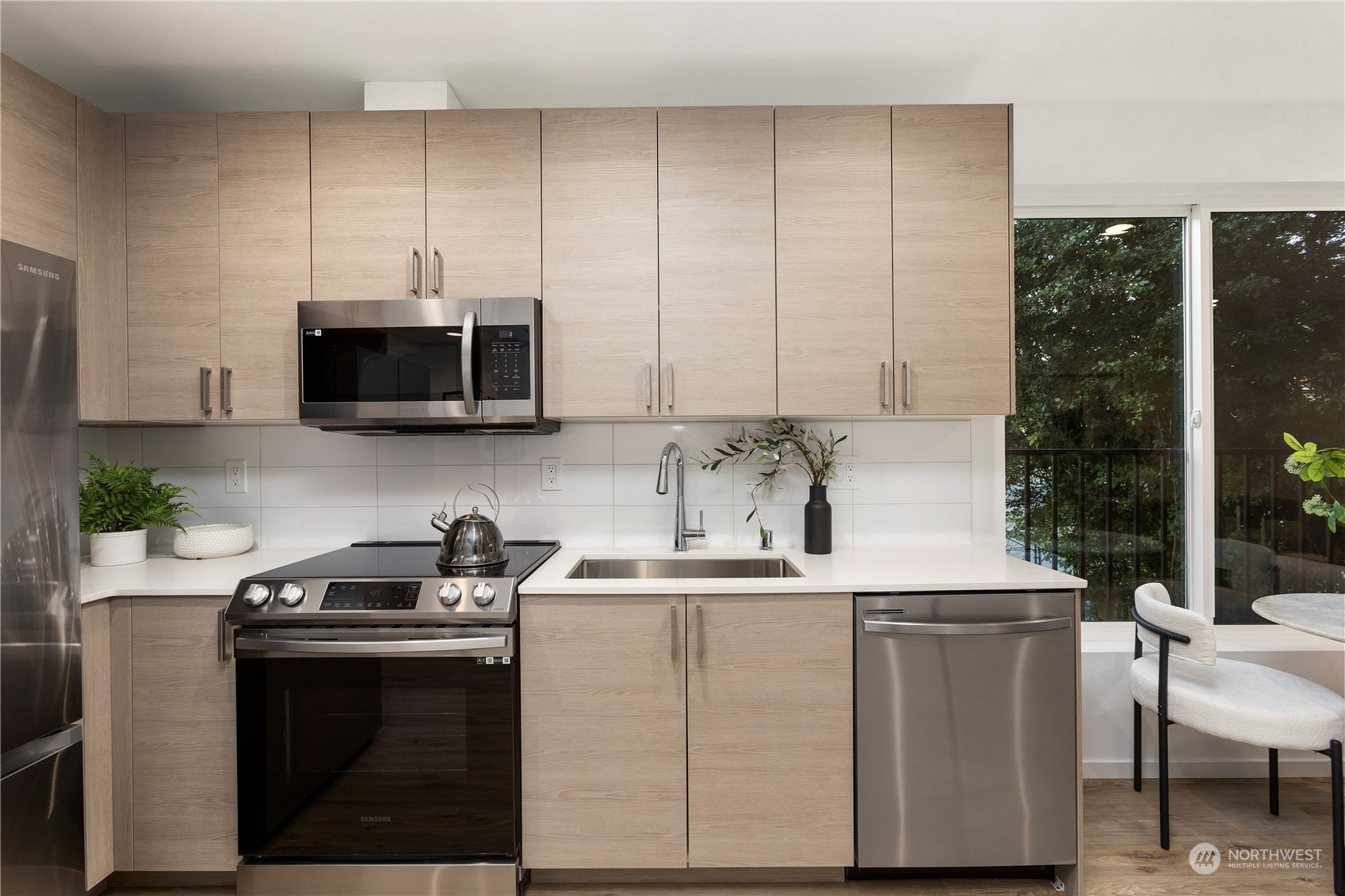3102 South Walden Street Seattle, WA 98144 - Photo 11 of 35 a kitchen with stainless steel appliances a microwave sink and cabinets