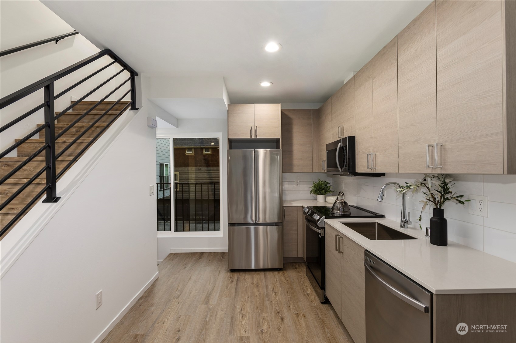 3102 South Walden Street Seattle, WA 98144 - Photo 8 of 35 a kitchen with stainless steel appliances a refrigerator and a sink