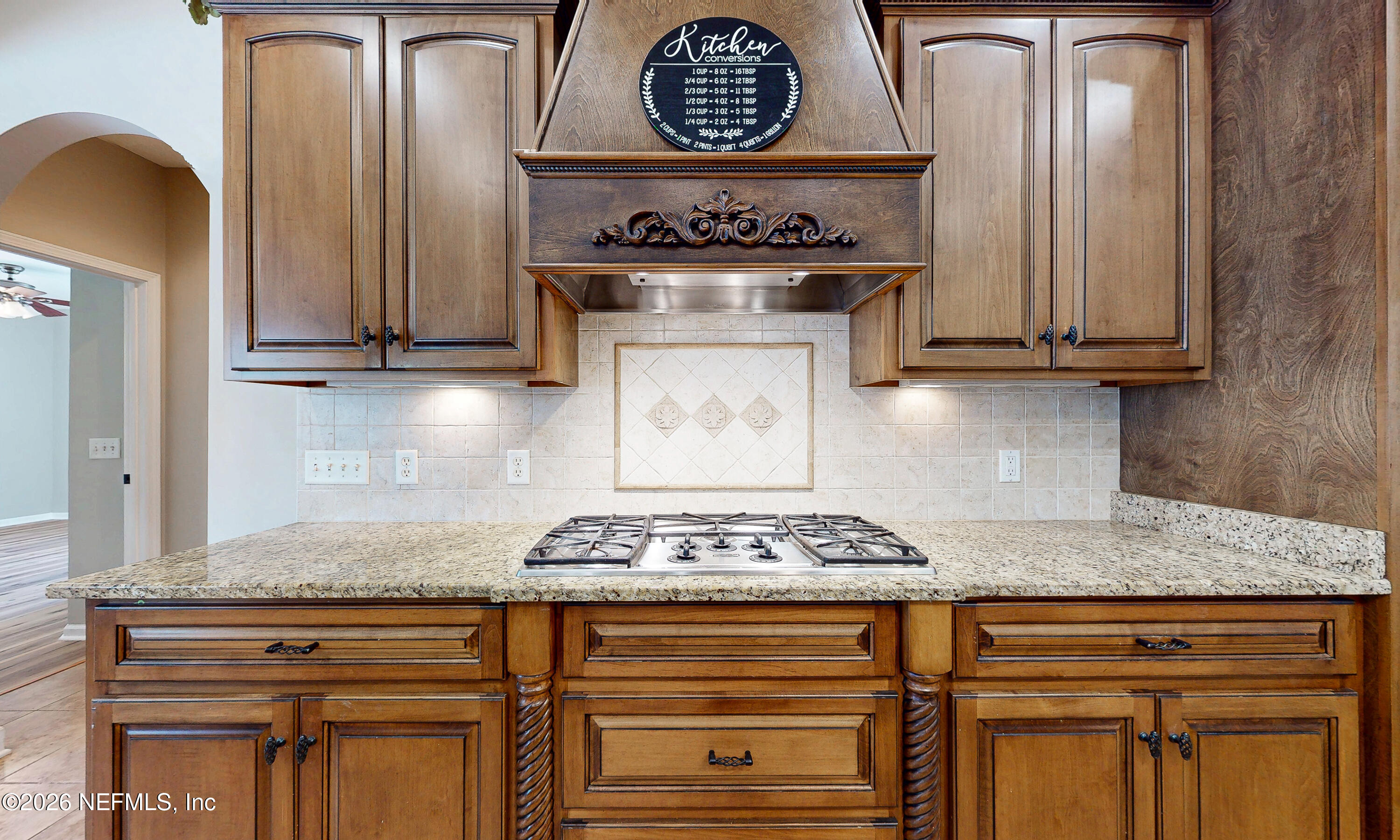 391595 Prospect Landing Hilliard, FL 32046 - Photo 17 of 69 a kitchen with granite countertop a stove and cabinets