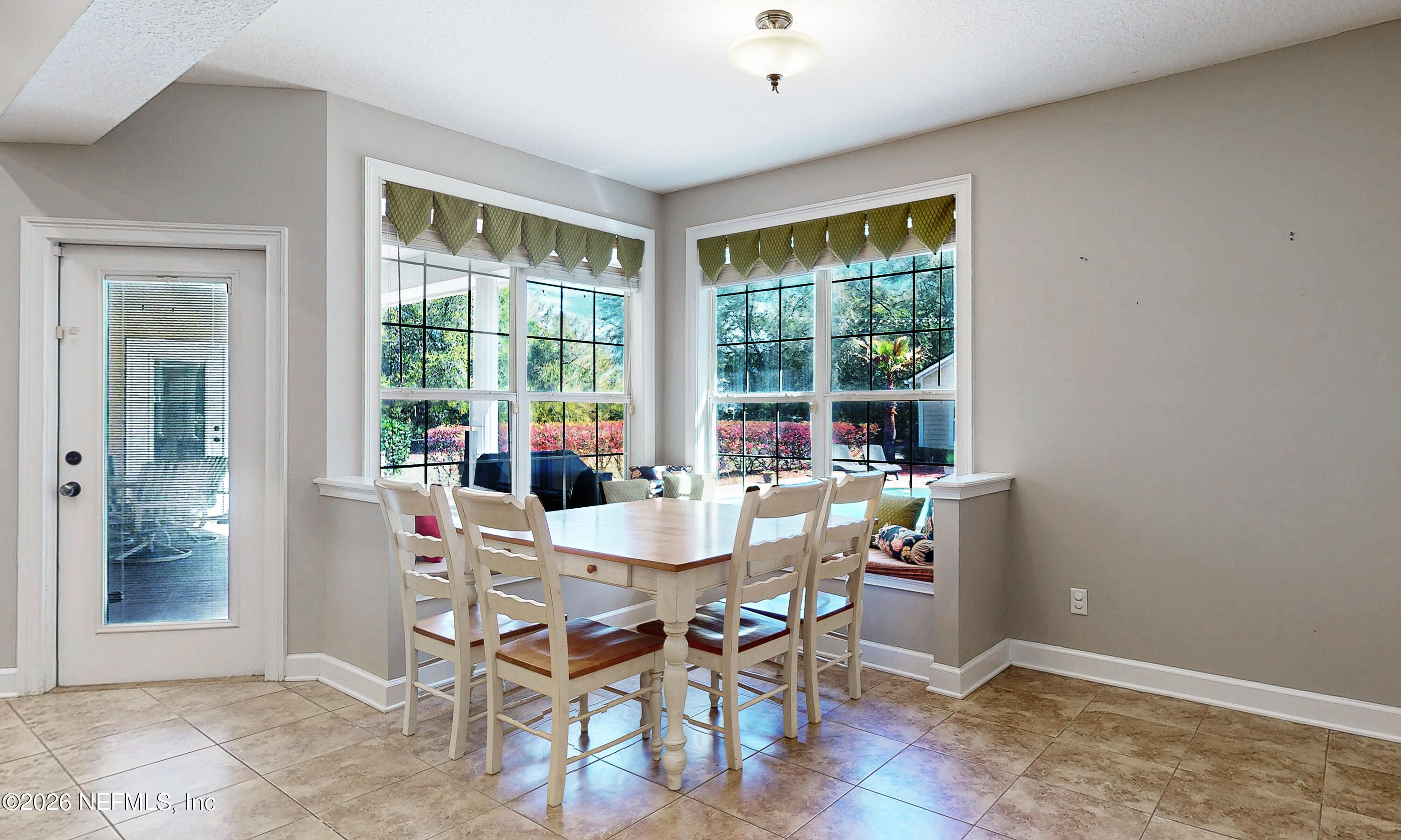 391595 Prospect Landing Hilliard, FL 32046 - Photo 20 of 69 a view of a dining room with furniture window and outside view