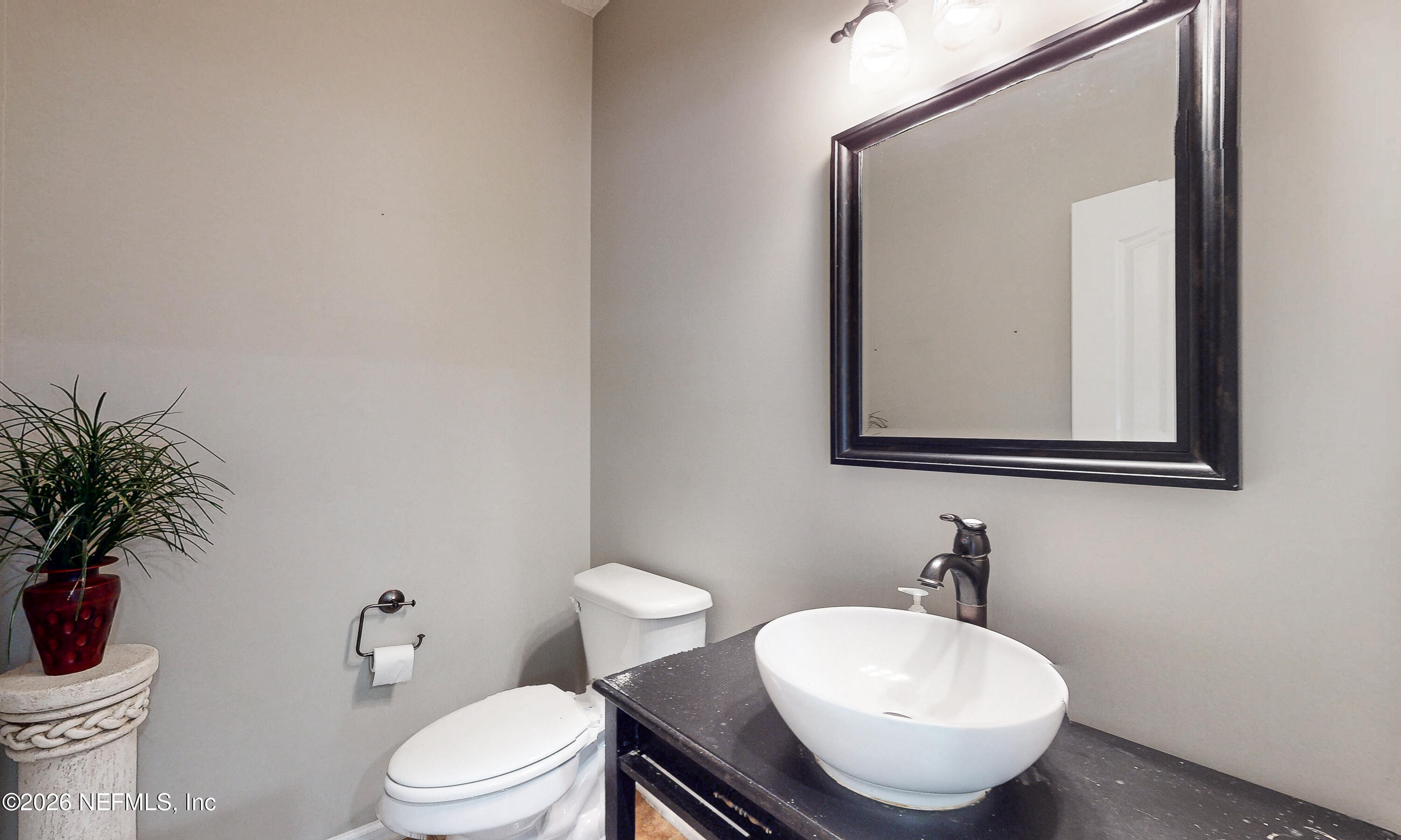 391595 Prospect Landing Hilliard, FL 32046 - Photo 22 of 69 a bathroom with a toilet a sink and mirror