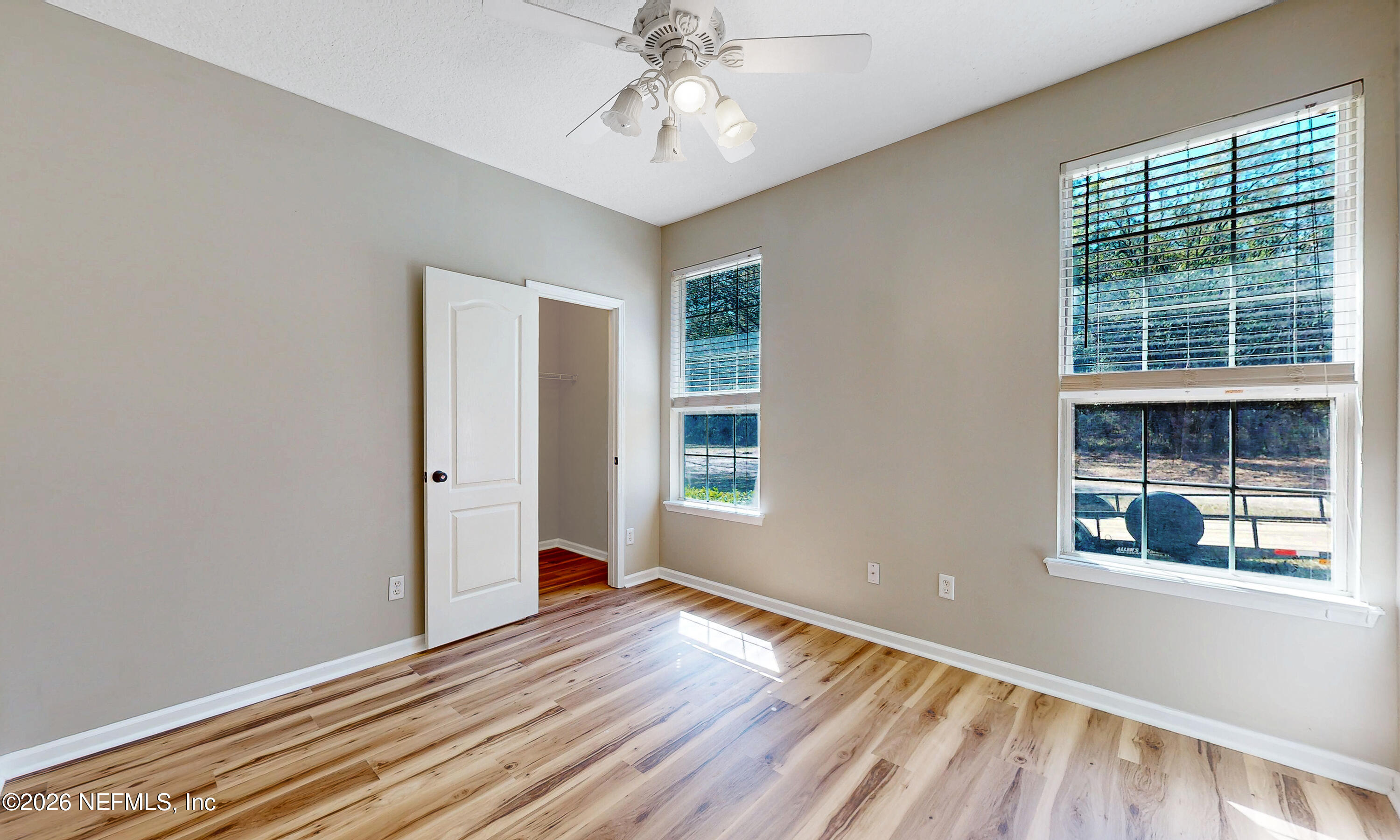391595 Prospect Landing Hilliard, FL 32046 - Photo 31 of 69 a view of an empty room with window and wooden floor