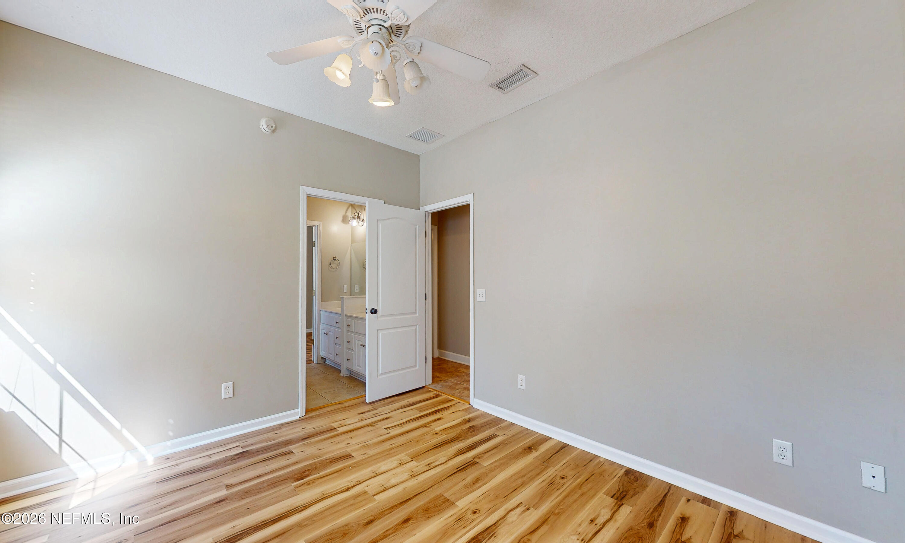 391595 Prospect Landing Hilliard, FL 32046 - Photo 32 of 69 a view of an empty room with wooden floor and a window