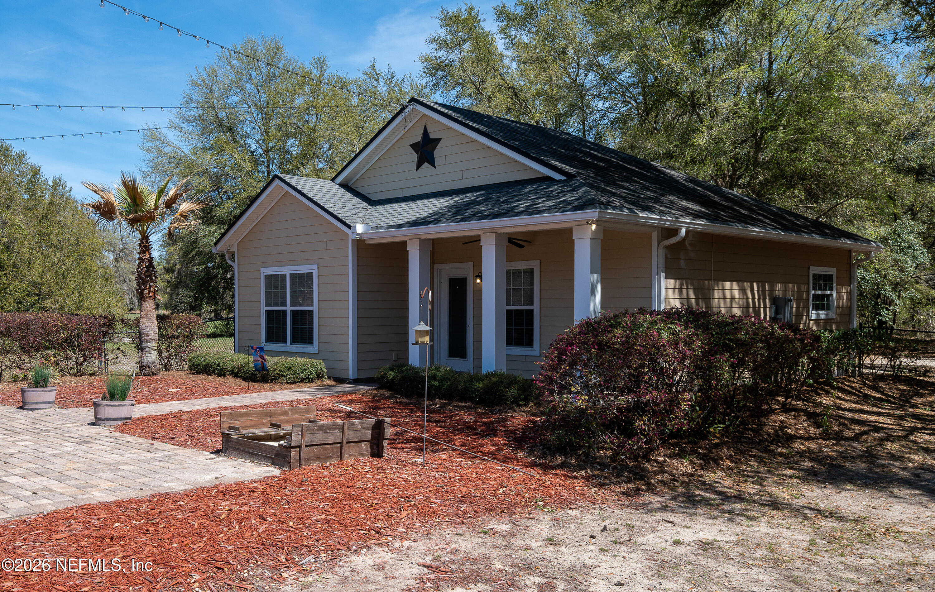 391595 Prospect Landing Hilliard, FL 32046 - Photo 46 of 69 a front view of house with yard and trees around