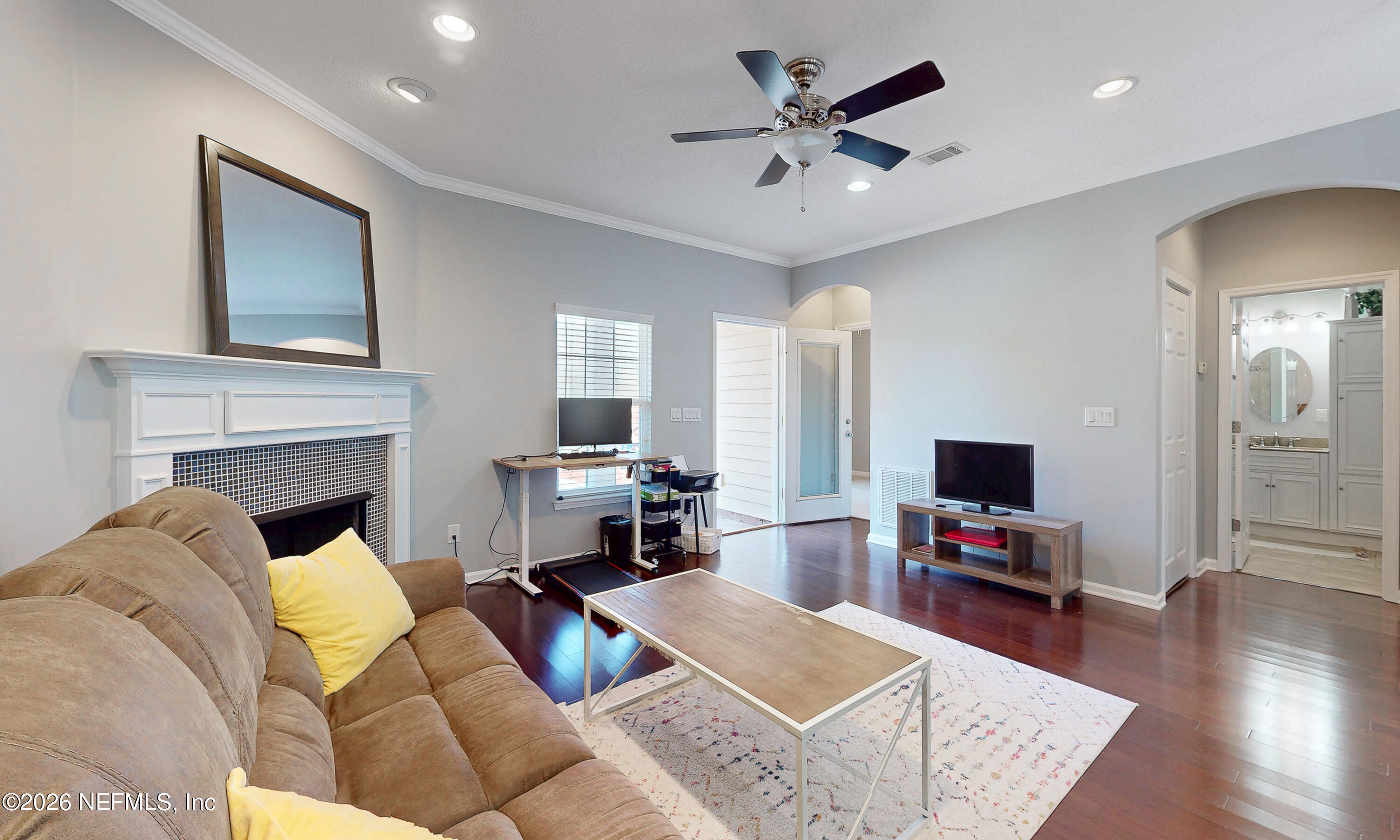 391595 Prospect Landing Hilliard, FL 32046 - Photo 51 of 69 a living room with furniture a fireplace and a flat screen tv