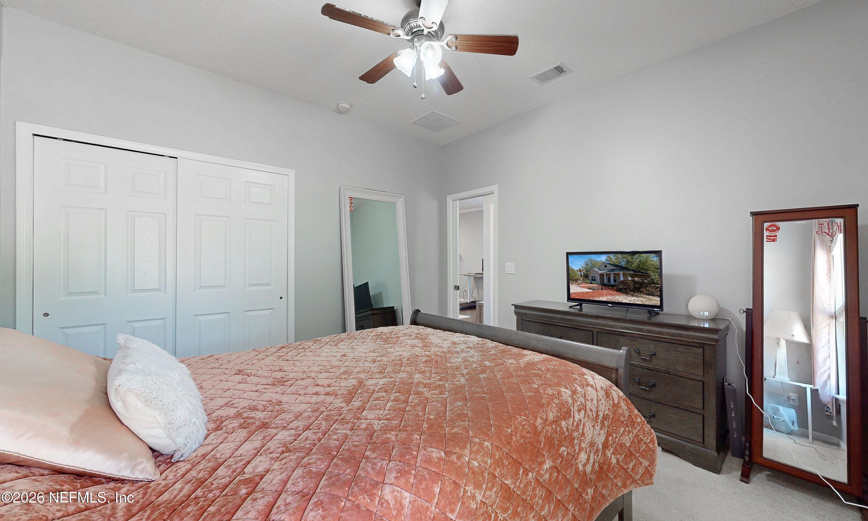 391595 Prospect Landing Hilliard, FL 32046 - Photo 57 of 69 a bedroom with a bed and a flat screen tv