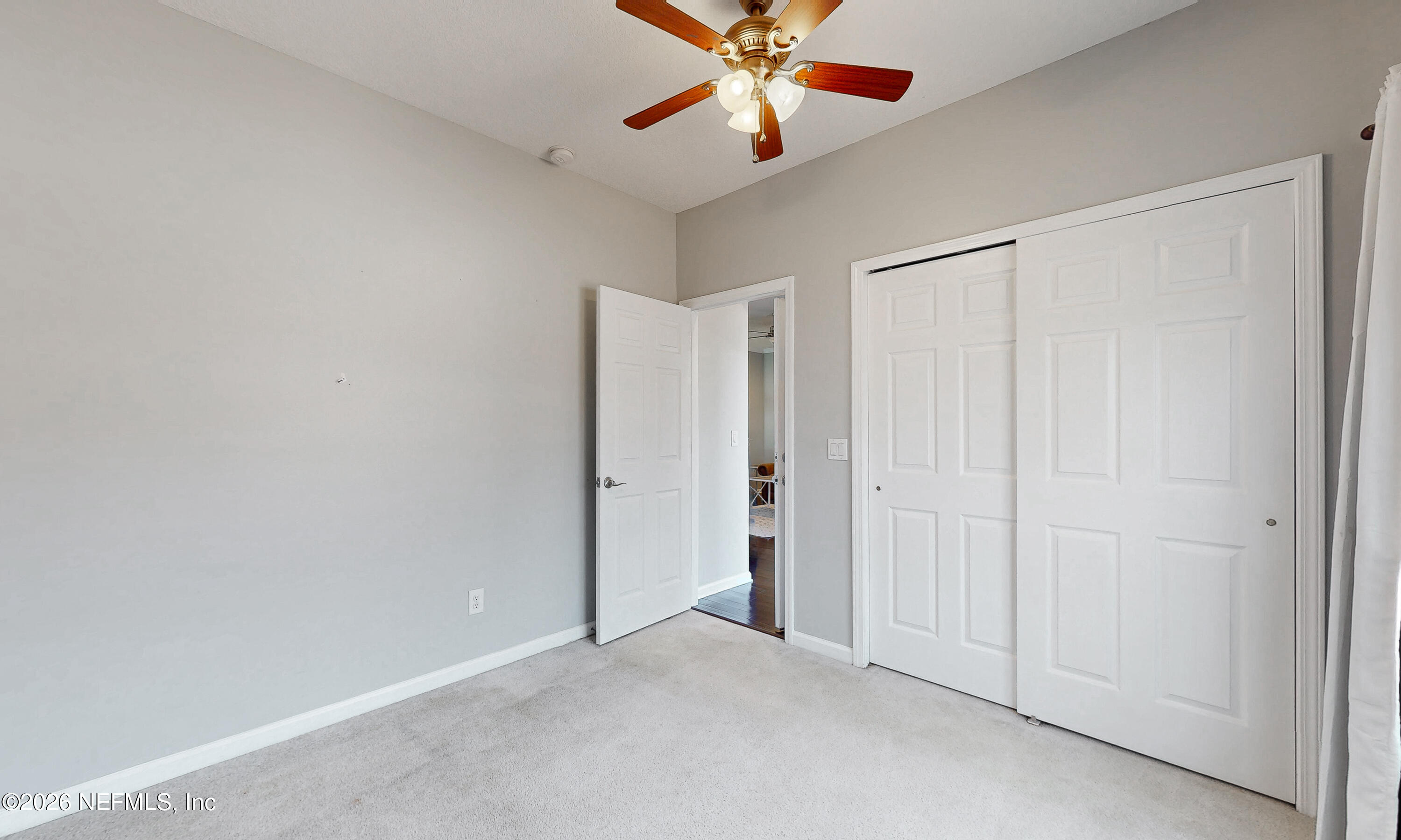 391595 Prospect Landing Hilliard, FL 32046 - Photo 61 of 69 an empty room with closet and a chandelier fan