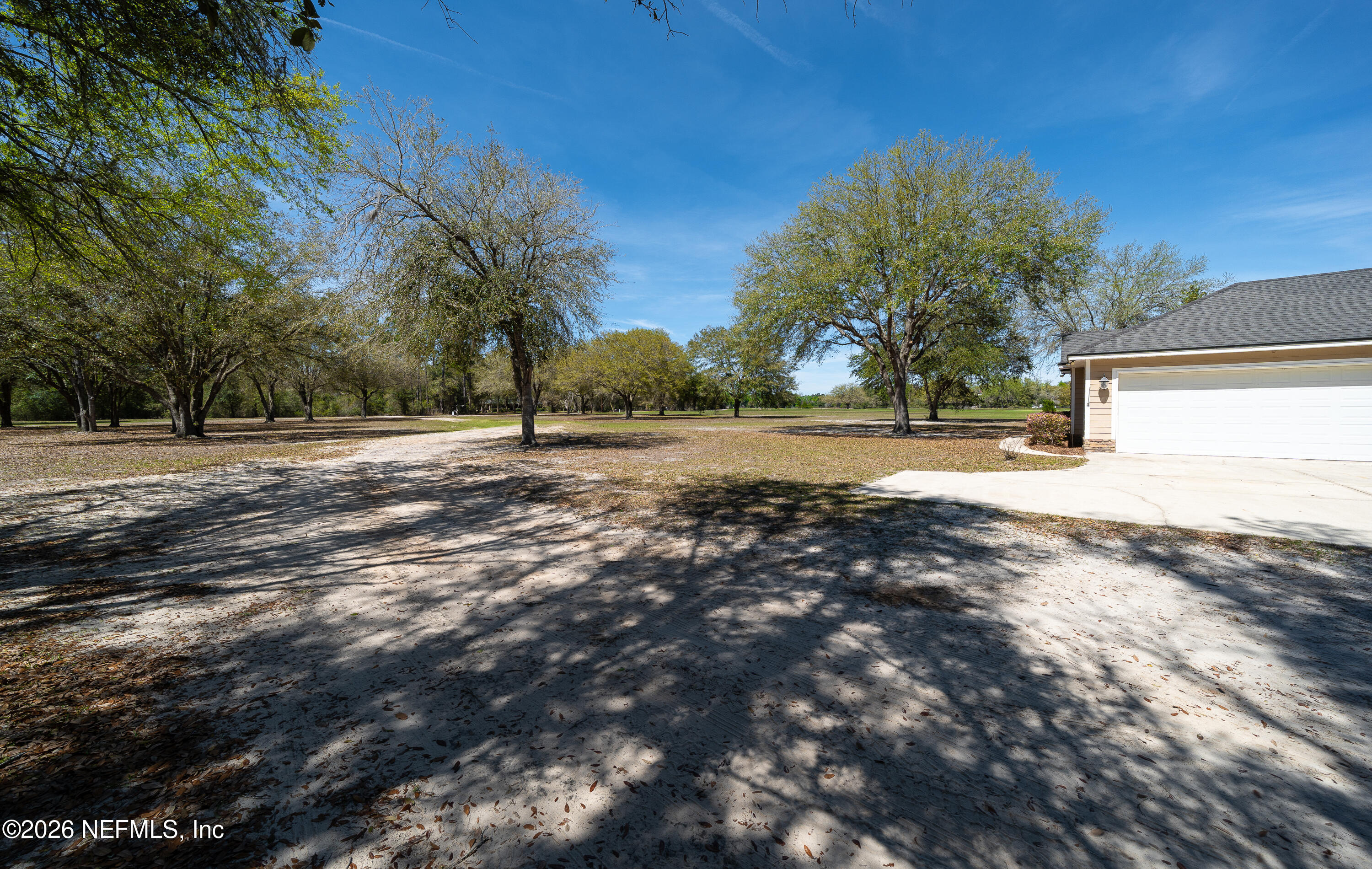 391595 Prospect Landing Hilliard, FL 32046 - Photo 63 of 69 a view of dirt yard with large trees