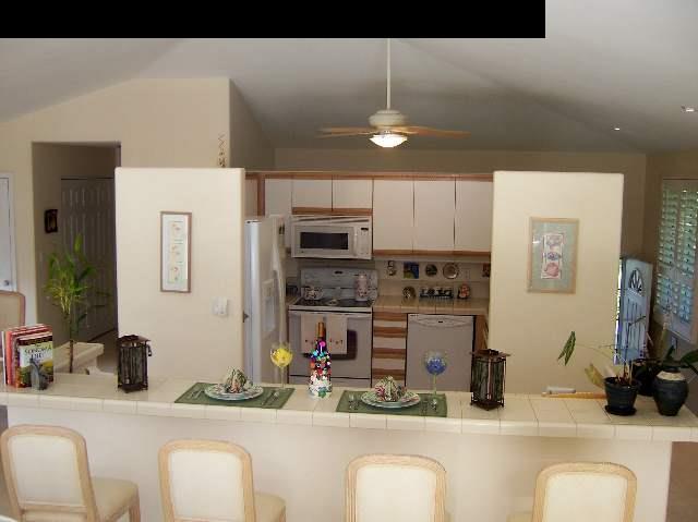 2811 Liholani Street, Unit 4 Pukalani, HI 96768 - Photo 11 of 22 a kitchen with stainless steel appliances kitchen island granite countertop a sink and white cabinets