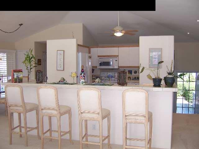 2811 Liholani Street, Unit 4 Pukalani, HI 96768 - Photo 7 of 22 a living room with stainless steel appliances kitchen island granite countertop a dining table chairs and a refrigerator