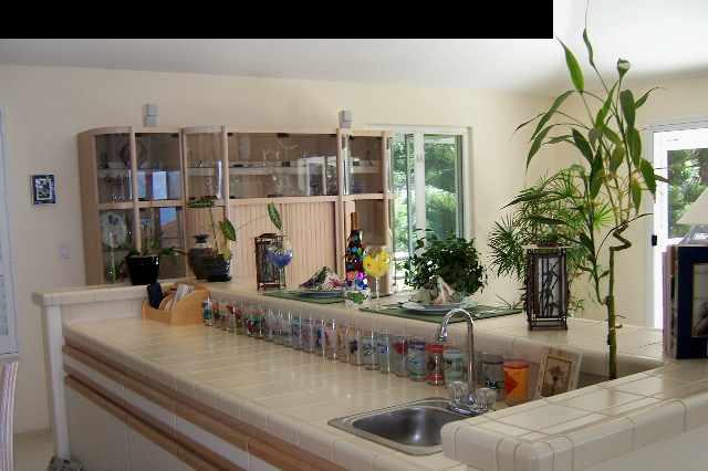 2811 Liholani Street, Unit 4 Pukalani, HI 96768 - Photo 10 of 22 a kitchen with a faucet a potted plant and a table