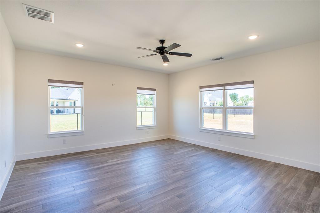311 Dobbs Trail Springtown, TX 76082 - Photo 21 of 33 a view of a livingroom with a hardwood floor ceiling fan and windows