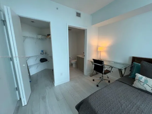 a view of a workspace with furniture and a wooden floor