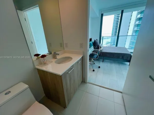 a bathroom with a sink a toilet and mirror