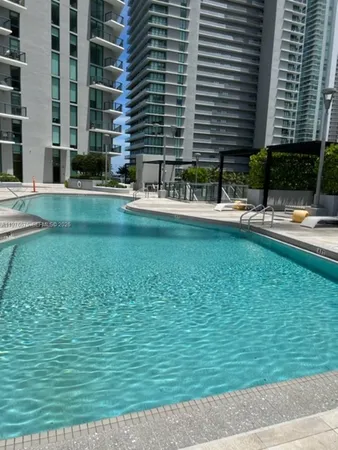 a swimming pool with outdoor seating and yard