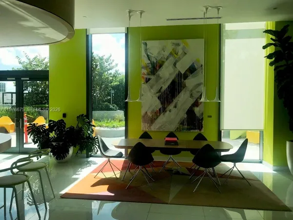 a room with patio furniture and a potted plant