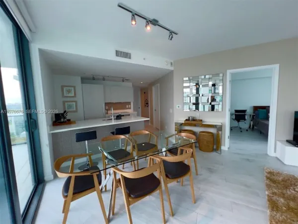 a view of a dining room with furniture and a chandelier