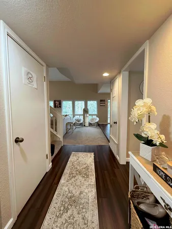 a view of a hallway with wooden floor