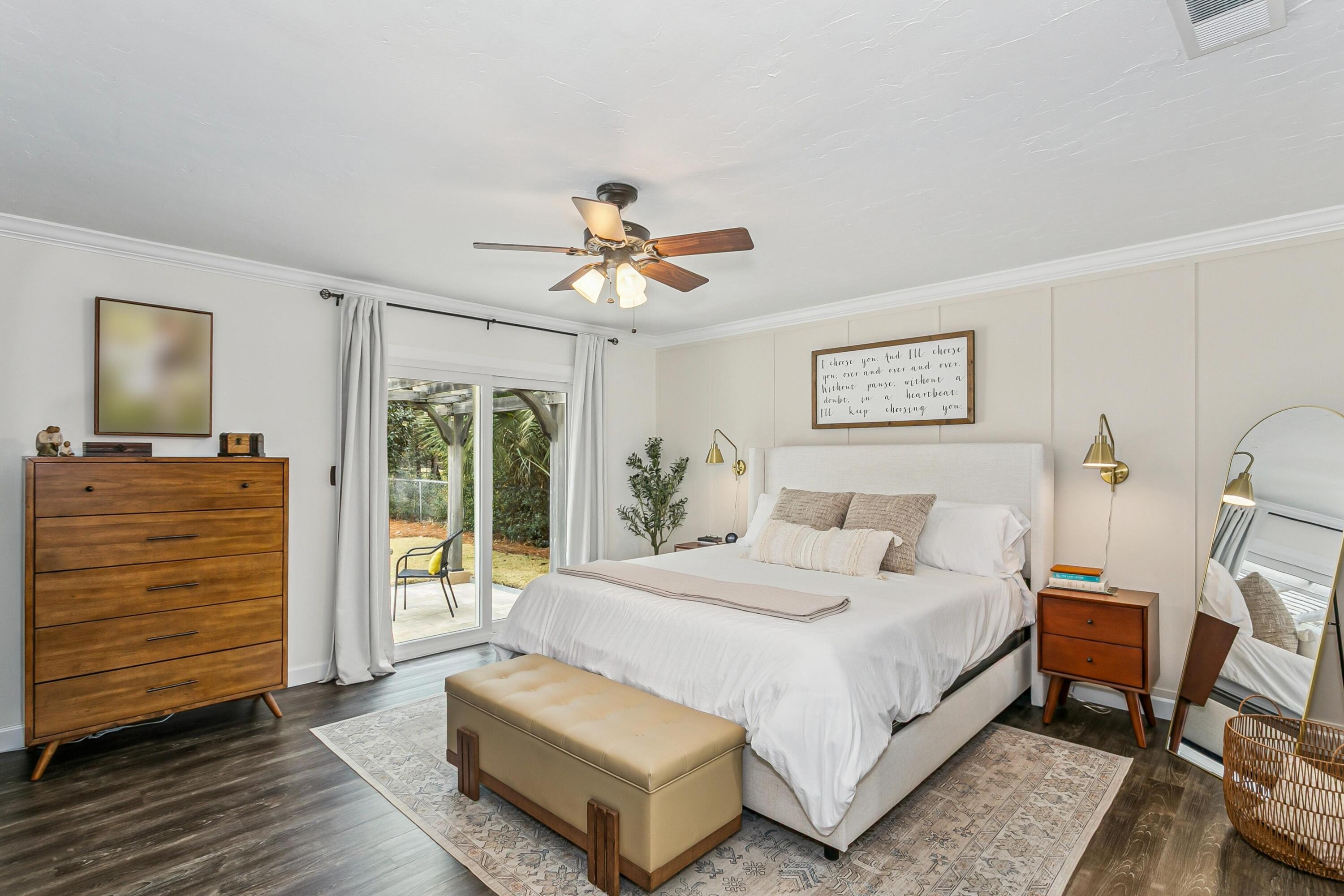 76 Country Club Road Shalimar, FL 32579 - Photo 15 of 47 a bedroom with a bed a dresser and a walk in closet