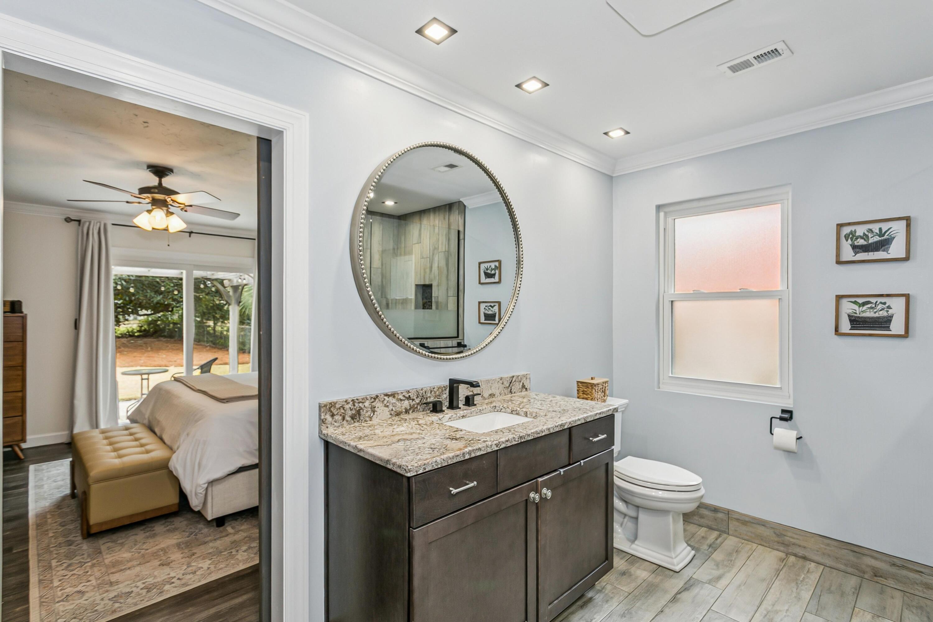 76 Country Club Road Shalimar, FL 32579 - Photo 18 of 47 a bathroom with a toilet a sink and mirror
