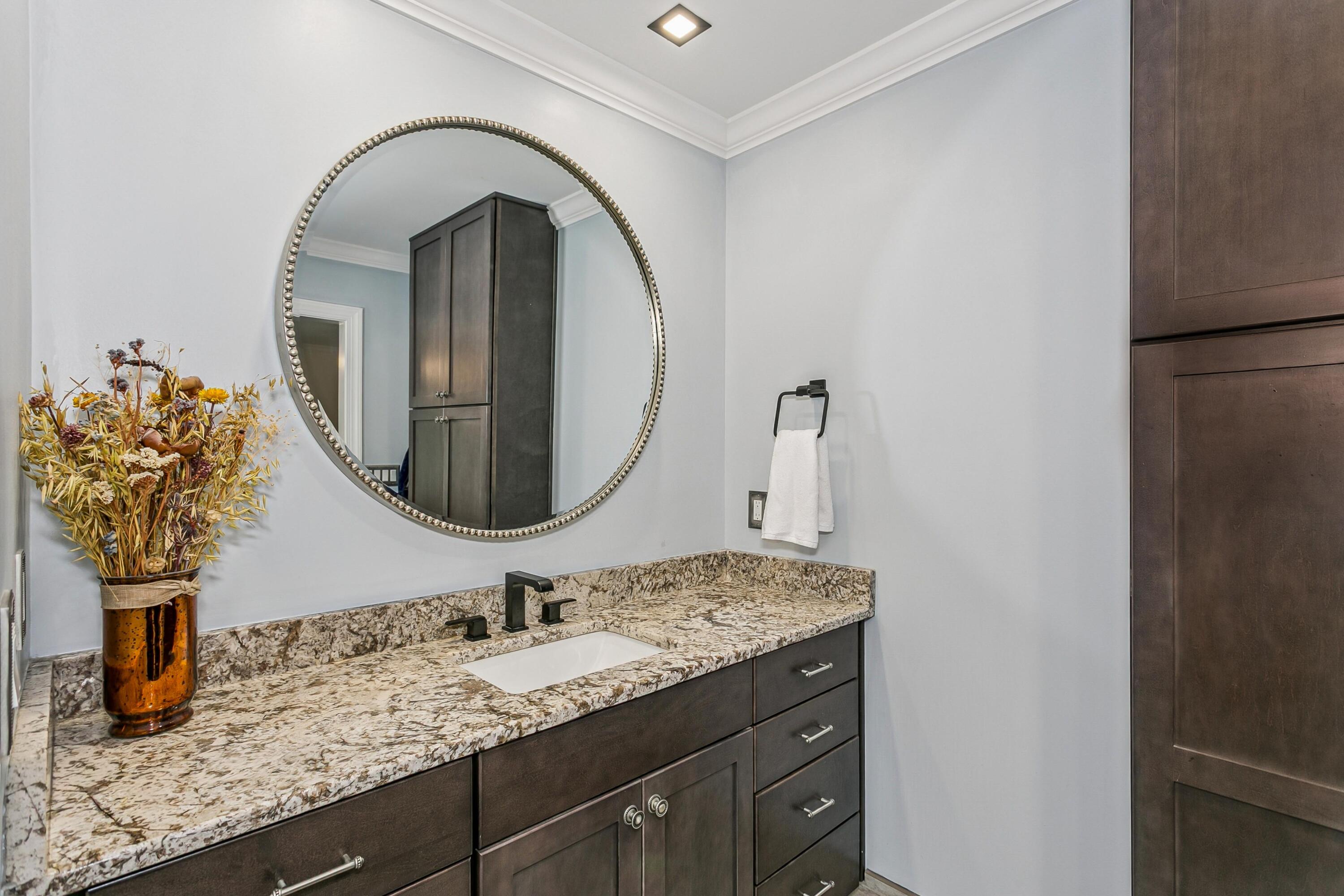 76 Country Club Road Shalimar, FL 32579 - Photo 19 of 47 a bathroom with a granite countertop sink a large mirror and vanity