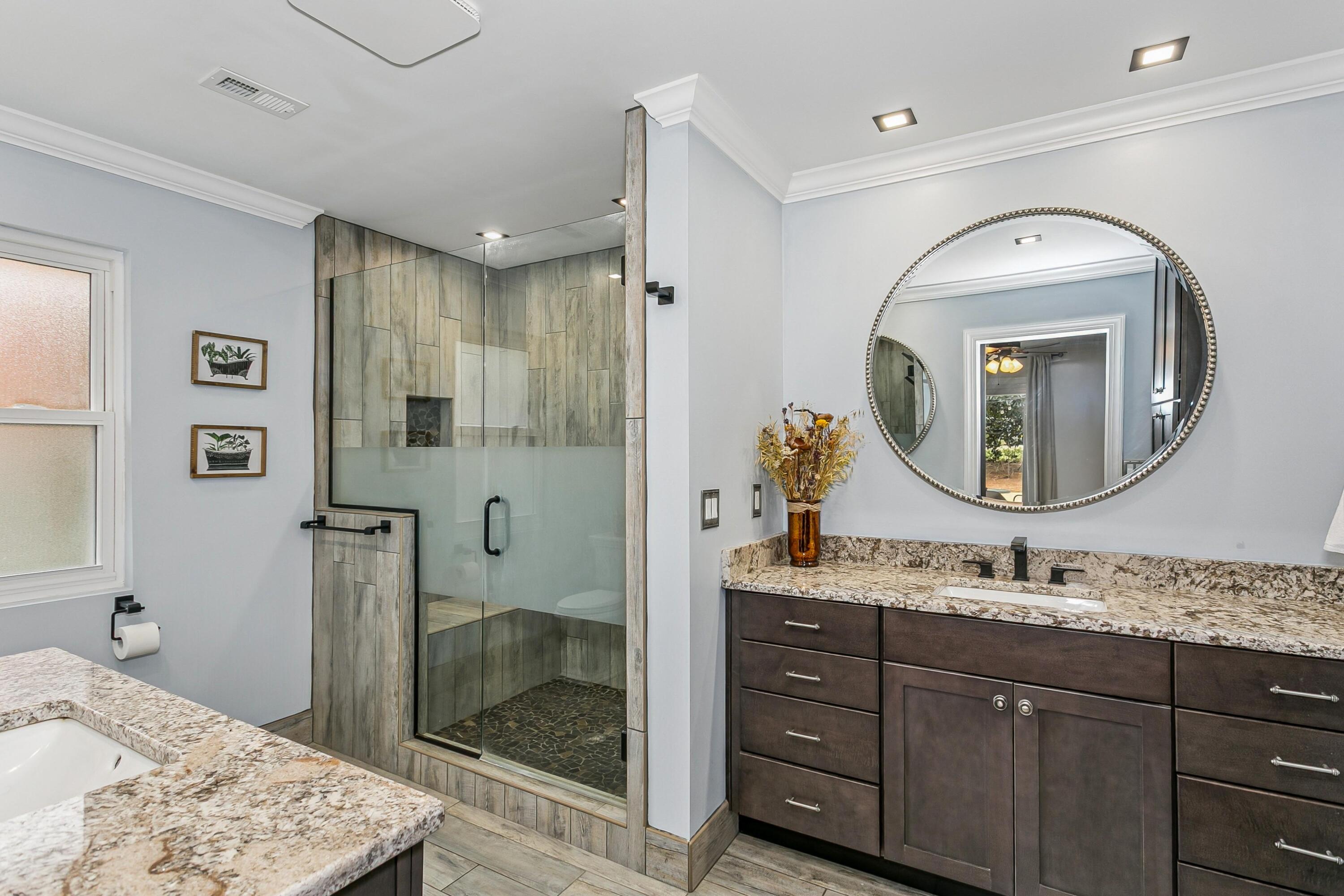 76 Country Club Road Shalimar, FL 32579 - Photo 22 of 47 a bathroom with a sink a mirror and a shower