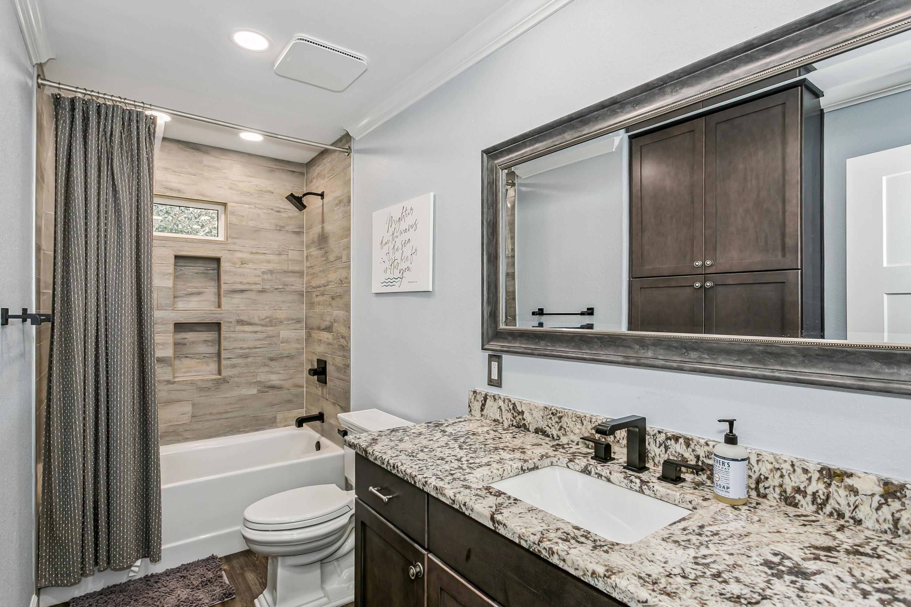 76 Country Club Road Shalimar, FL 32579 - Photo 26 of 47 a bathroom with a granite countertop sink toilet and shower