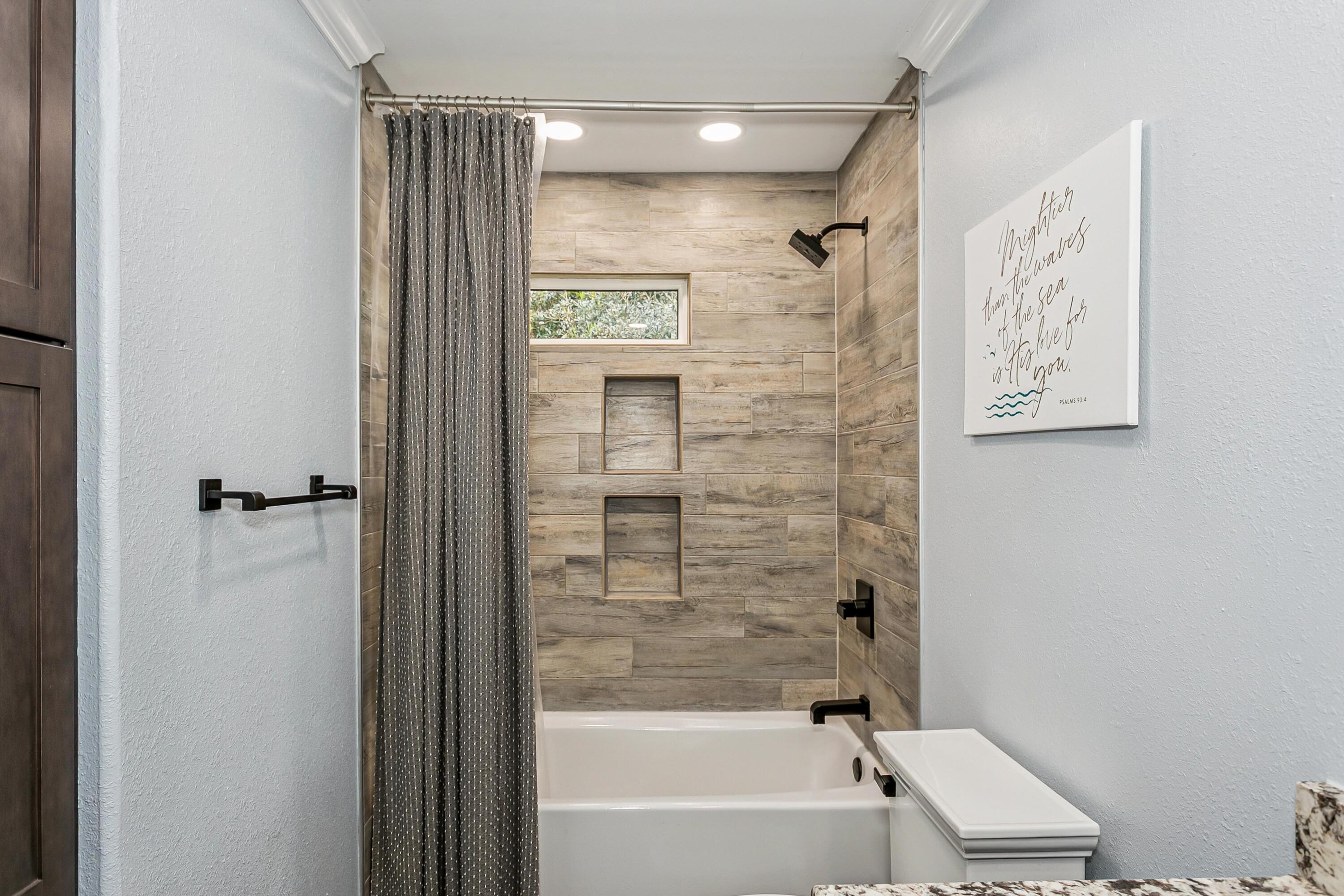 76 Country Club Road Shalimar, FL 32579 - Photo 27 of 47 a bathroom with a bathtub and a shower
