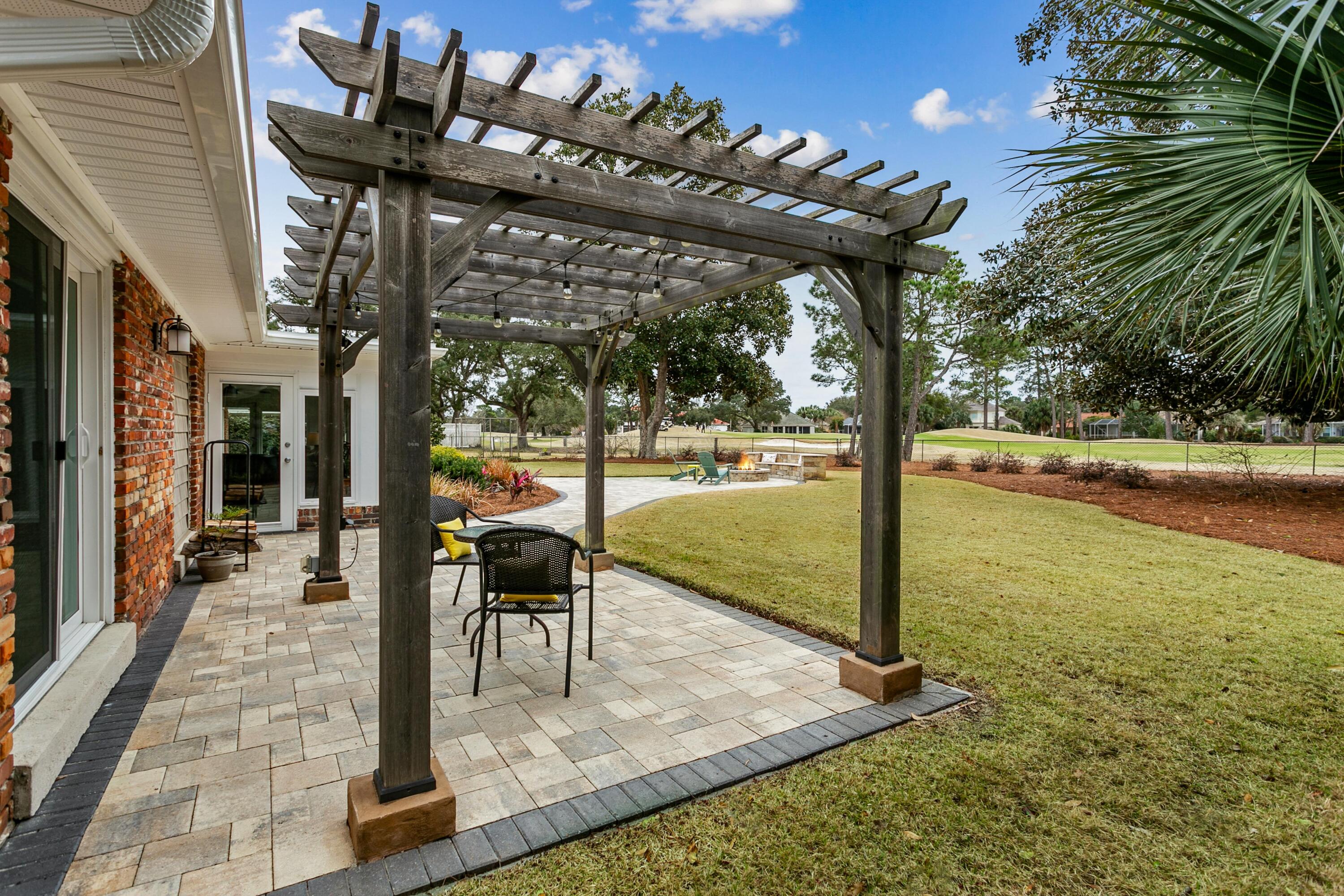 76 Country Club Road Shalimar, FL 32579 - Photo 34 of 47 a view of a swimming pool with a patio