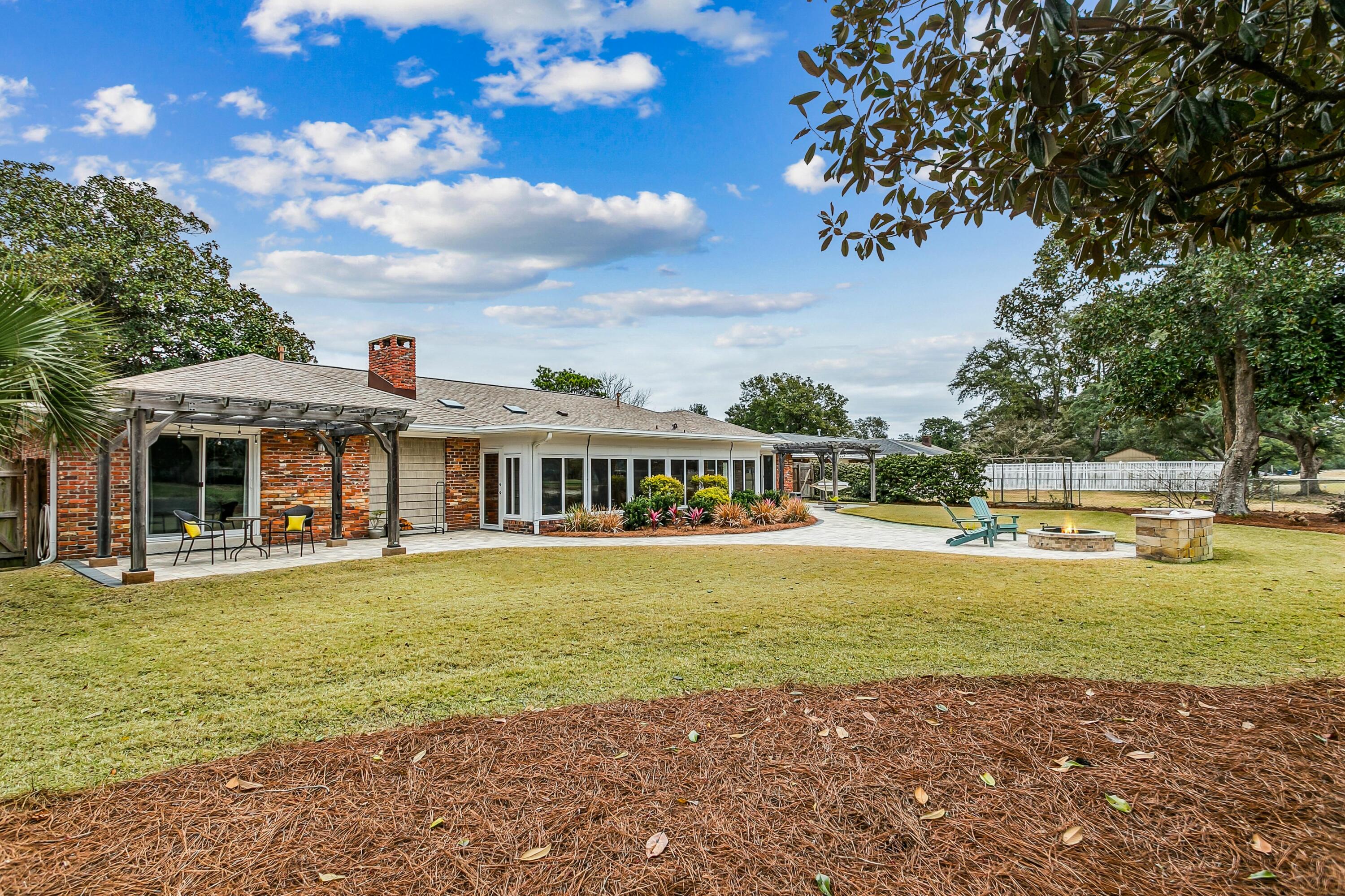 76 Country Club Road Shalimar, FL 32579 - Photo 40 of 47 a view of a house with swimming pool and a yard