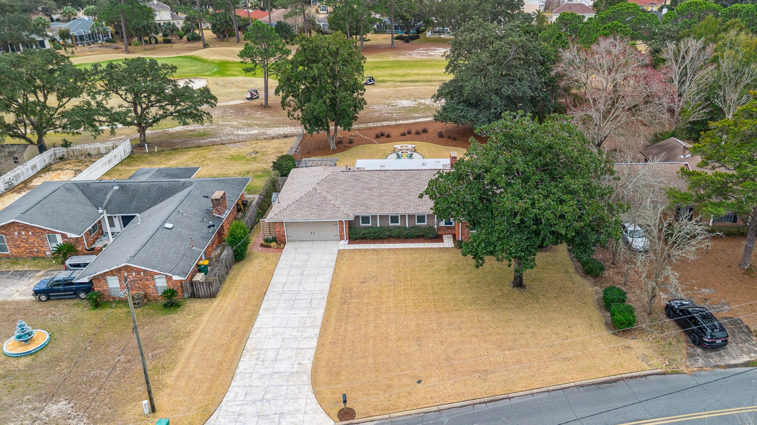 76 Country Club Road Shalimar, FL 32579 - Photo 44 of 47 an aerial view of a house with swimming pool and green space