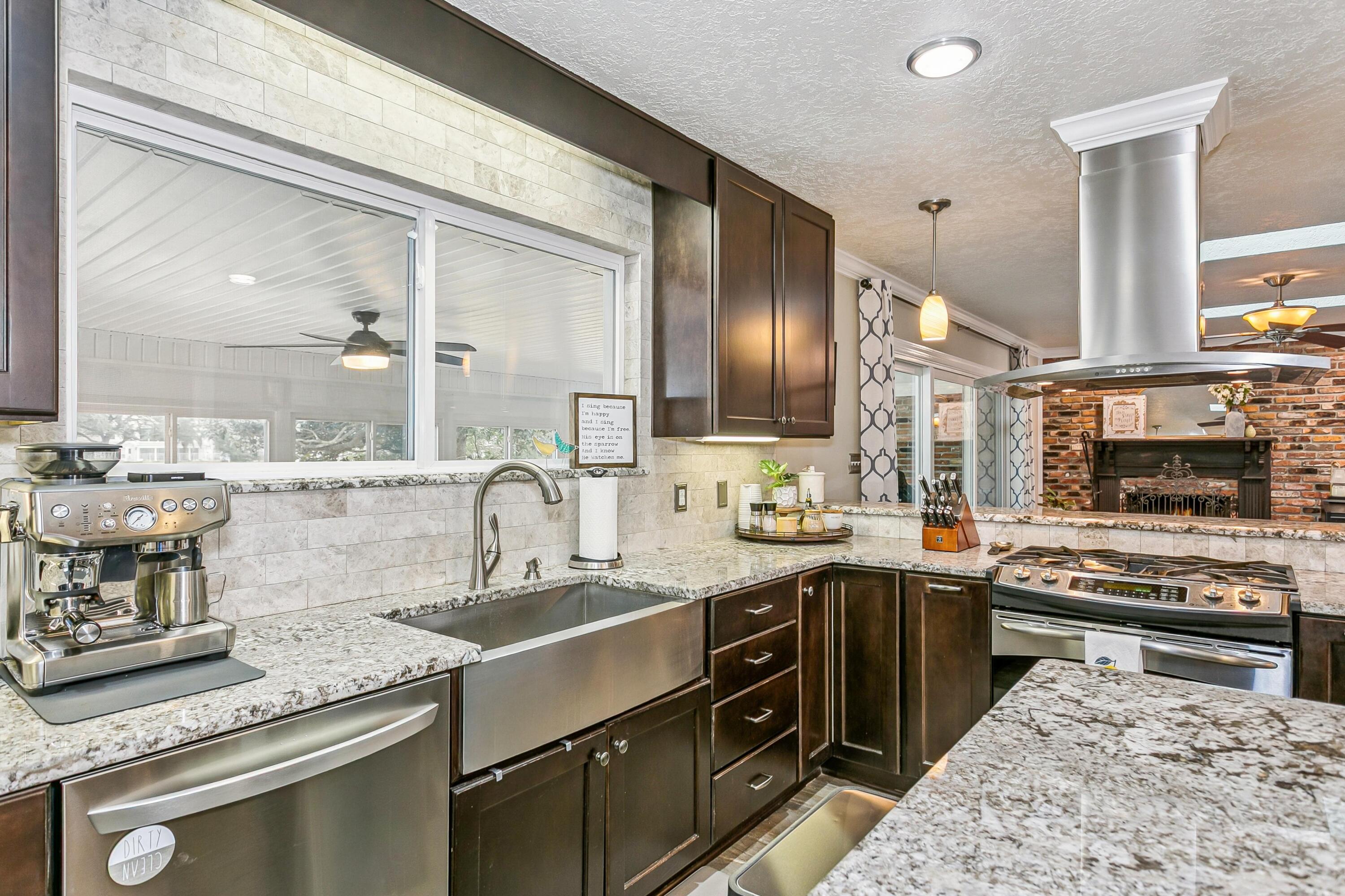 76 Country Club Road Shalimar, FL 32579 - Photo 8 of 47 a kitchen with stainless steel appliances granite countertop a sink stove and cabinets