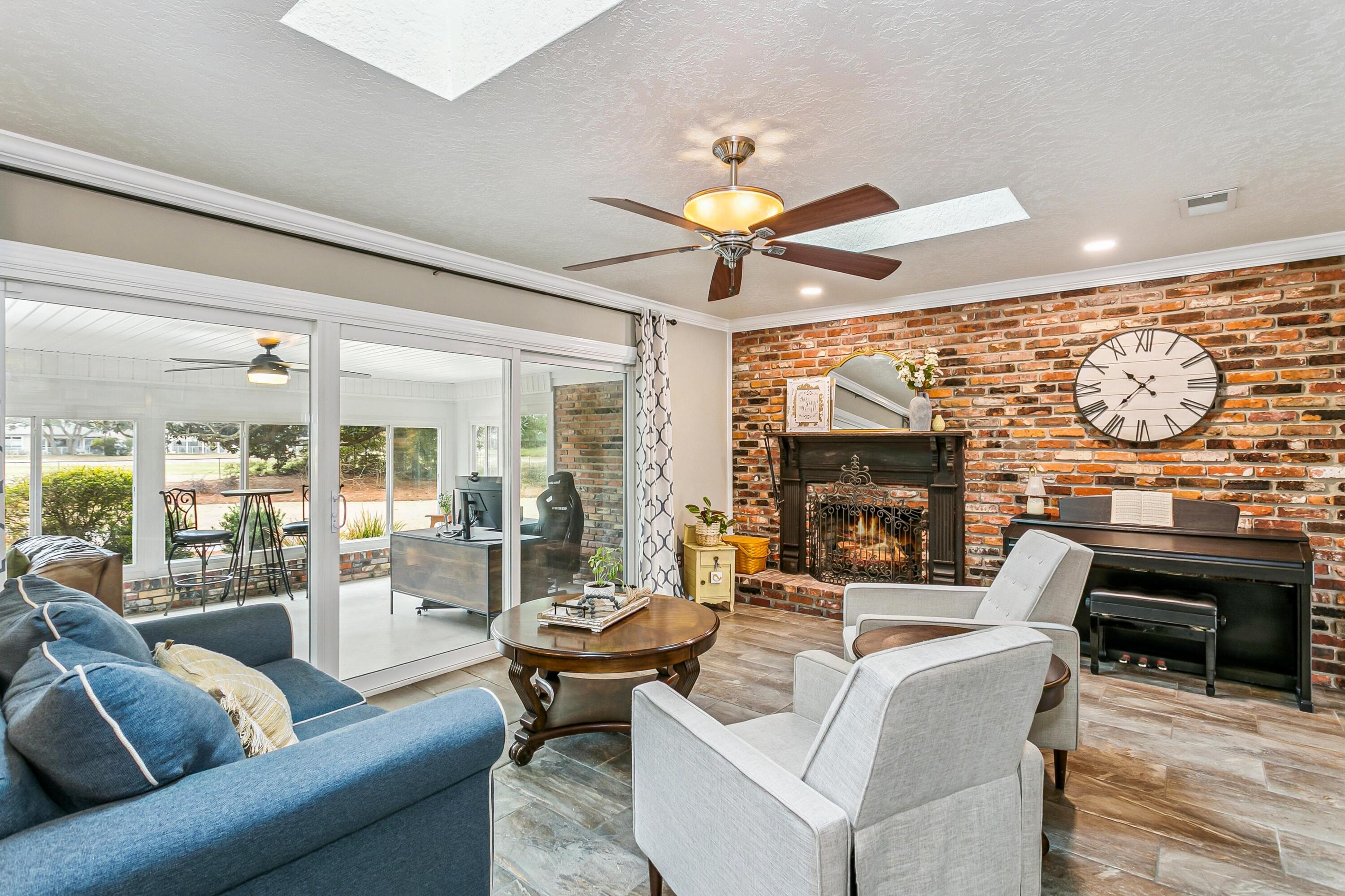 76 Country Club Road Shalimar, FL 32579 - Photo 9 of 47 a living room with fireplace furniture and a large window