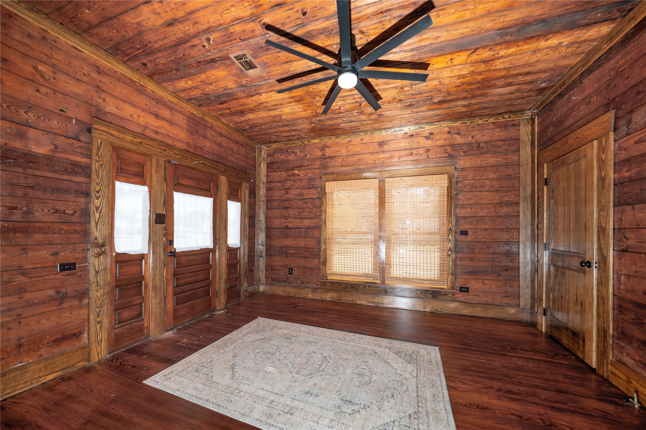 236 Main Street Grapeland, TX 75844 - Photo 18 of 31 an empty room with wooden floor and windows