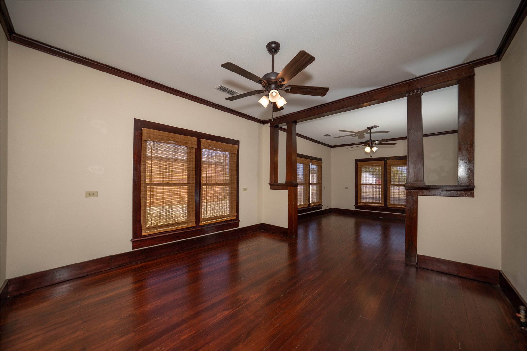 236 Main Street Grapeland, TX 75844 - Photo 4 of 31 a view of an empty room with window and wooden floor