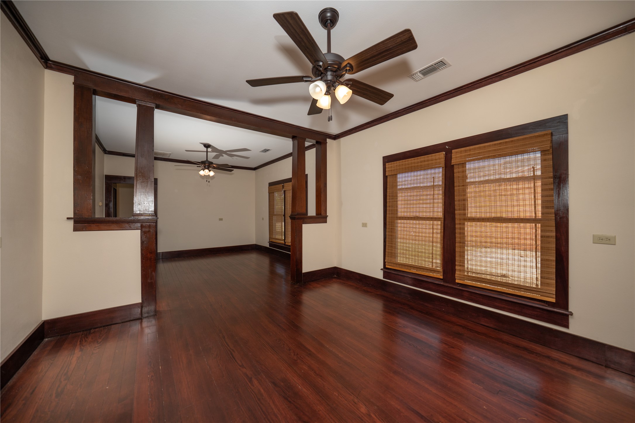 236 Main Street Grapeland, TX 75844 - Photo 5 of 31 a view of an empty room with a window and wooden floor