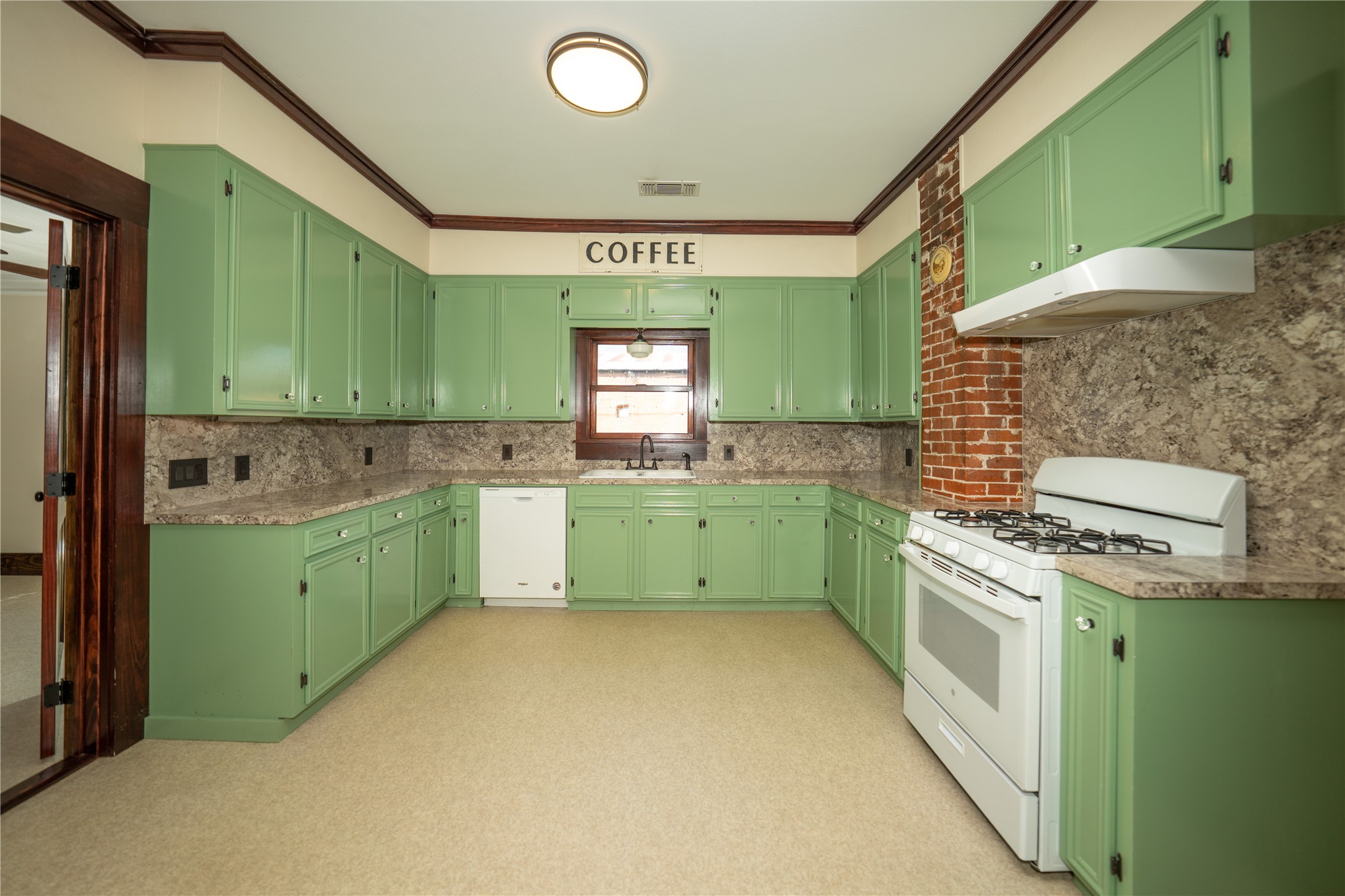236 Main Street Grapeland, TX 75844 - Photo 8 of 31 a kitchen with a sink cabinets and a wooden floors