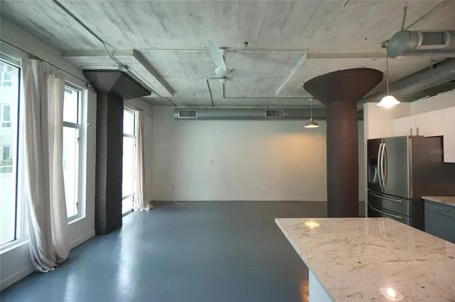 a view of a kitchen with a sink and stainless steel appliances