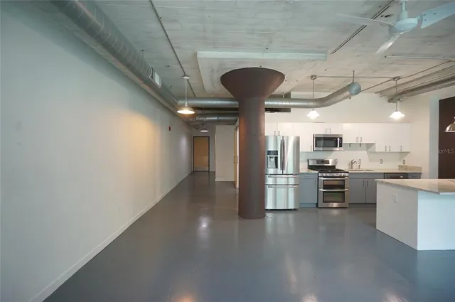 a kitchen with a sink and stainless steel appliances