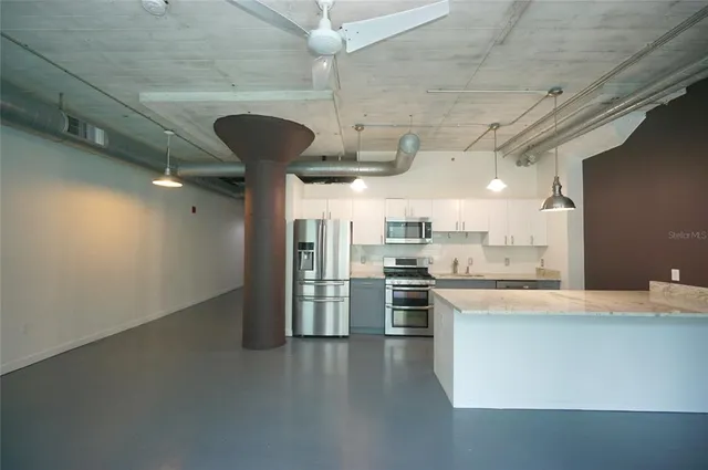 a bathroom with a granite countertop bathtub shower and toilet