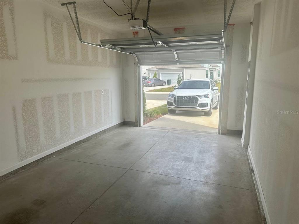 455 Redbud Road Palm Coast, FL 32137 - Photo 2 of 12 a view of a room with a garage