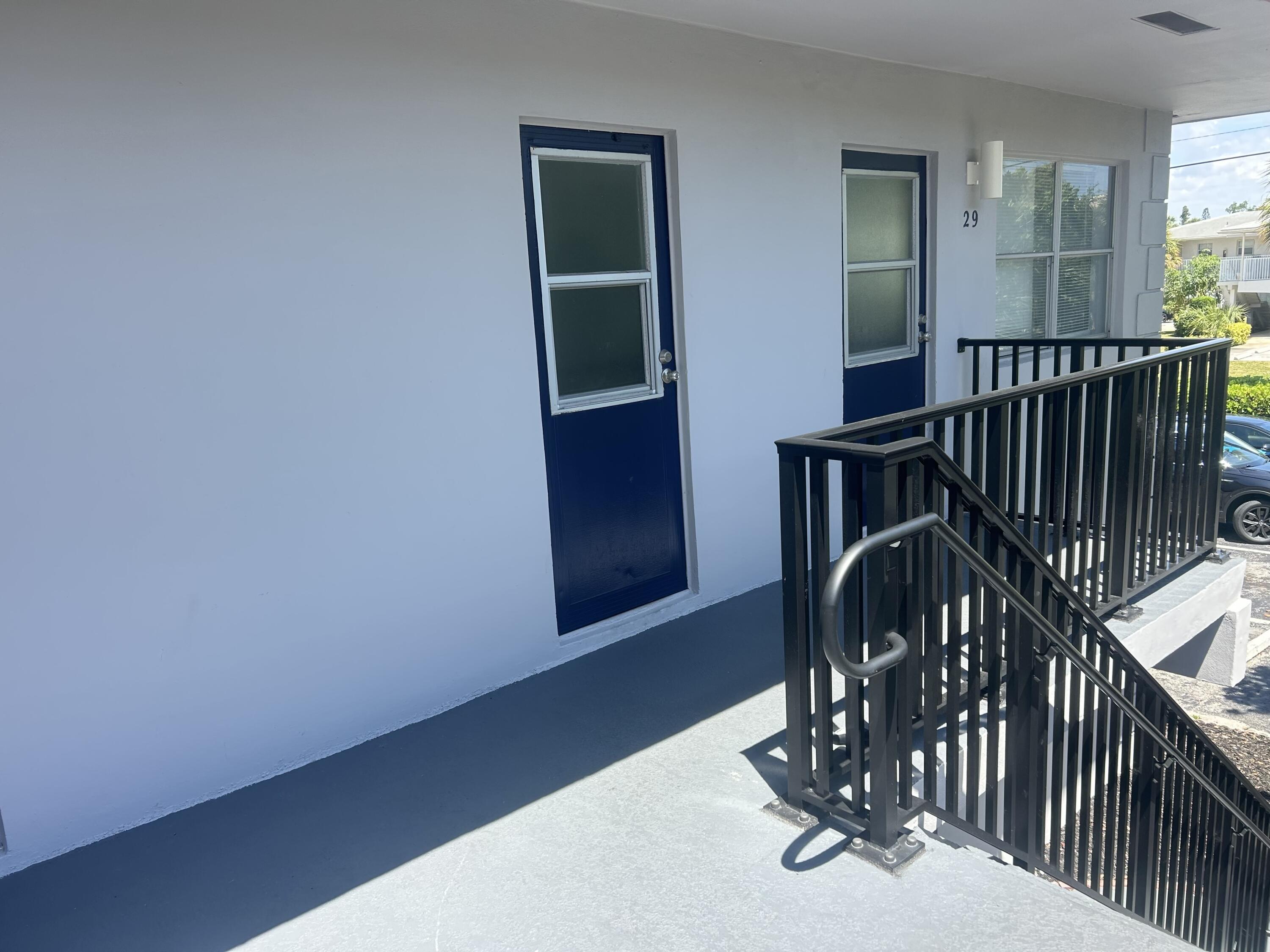 260 Northwest 19th Street, Unit 290 Boca Raton, FL 33432 - Photo 4 of 18 a view of a hallway with wooden floor and stairs